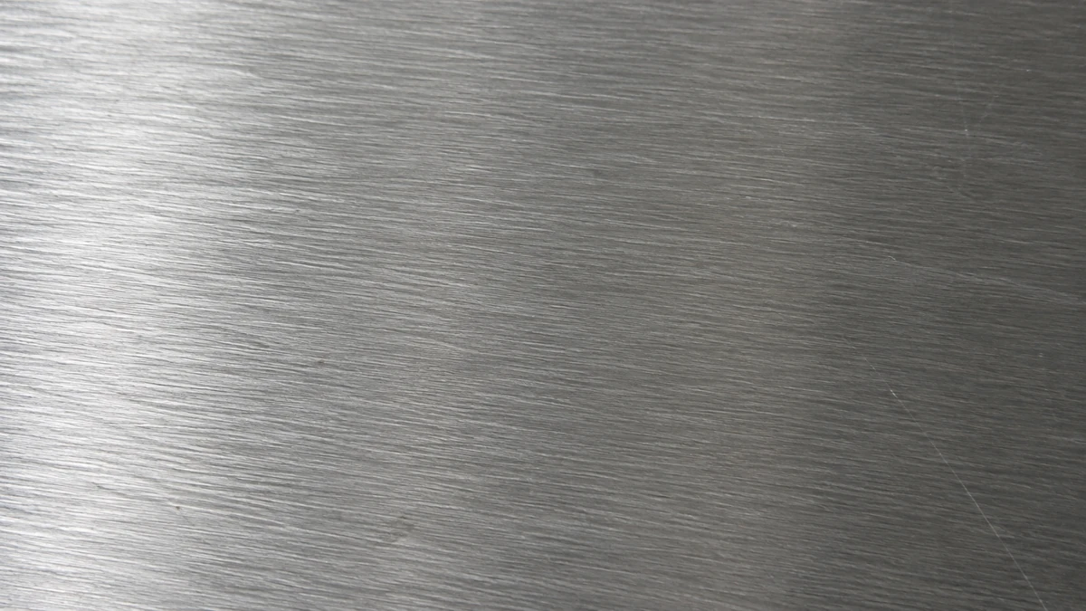 A brushed steel surface filling the frame, fine parallel grain lines.