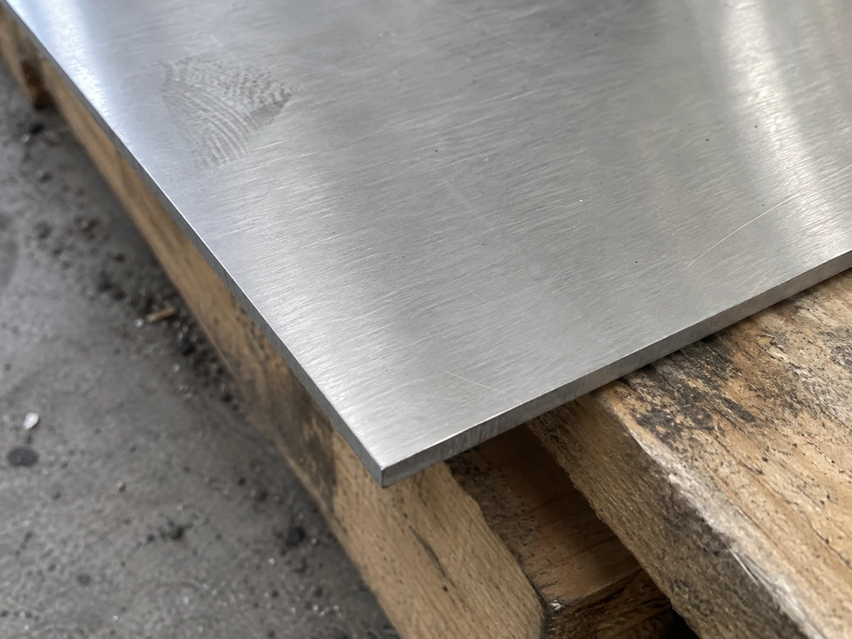 Close-up of a 304 stainless steel sheet corner with a clean cut edge.