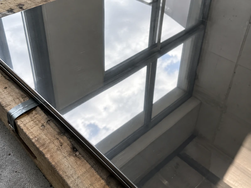 A window reflected in a BA stainless steel panel, the edges of the reflection sharp.