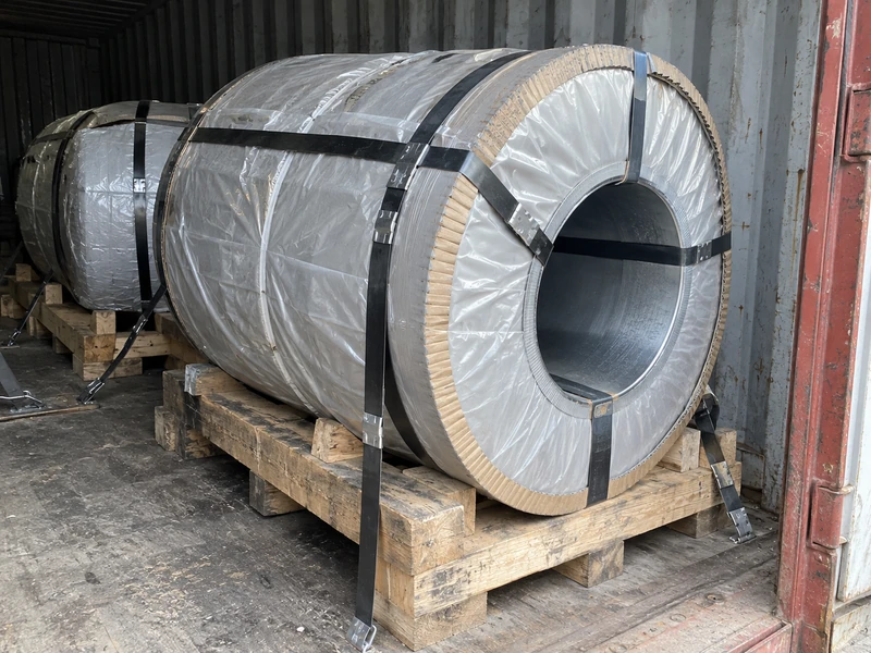 Cold rolled coils in moisture-proof wrapping on pallets, strapped inside a container.