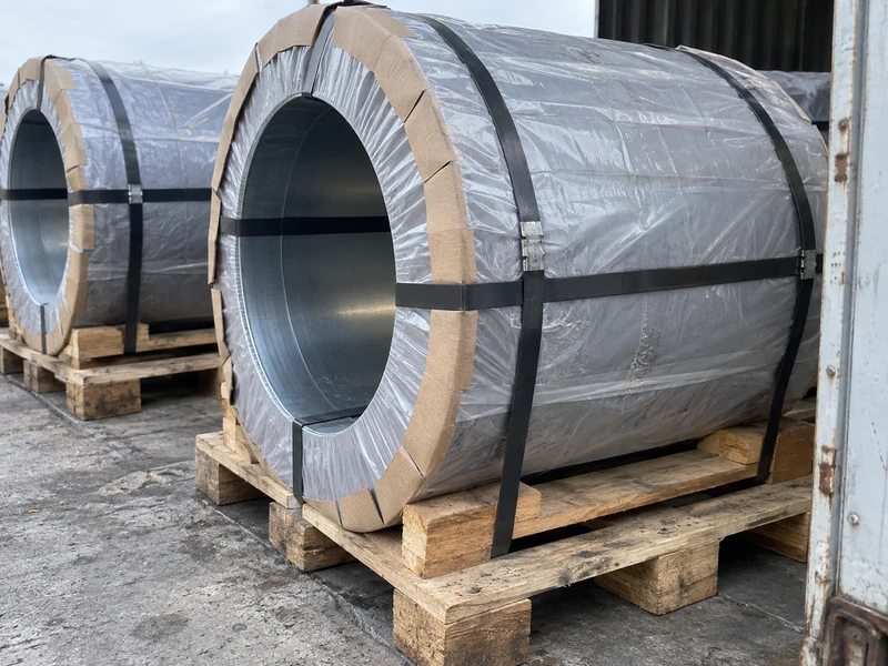 DC01 coils wrapped and strapped on pallets with edge protectors in place, ready to load.