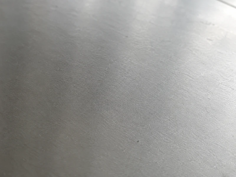 Close-up of a 304 stainless steel surface, smooth and evenly matte.