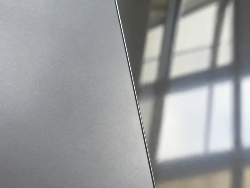A 430 sheet in BA finish beside one in 2B, the mirror surface against the matte one.